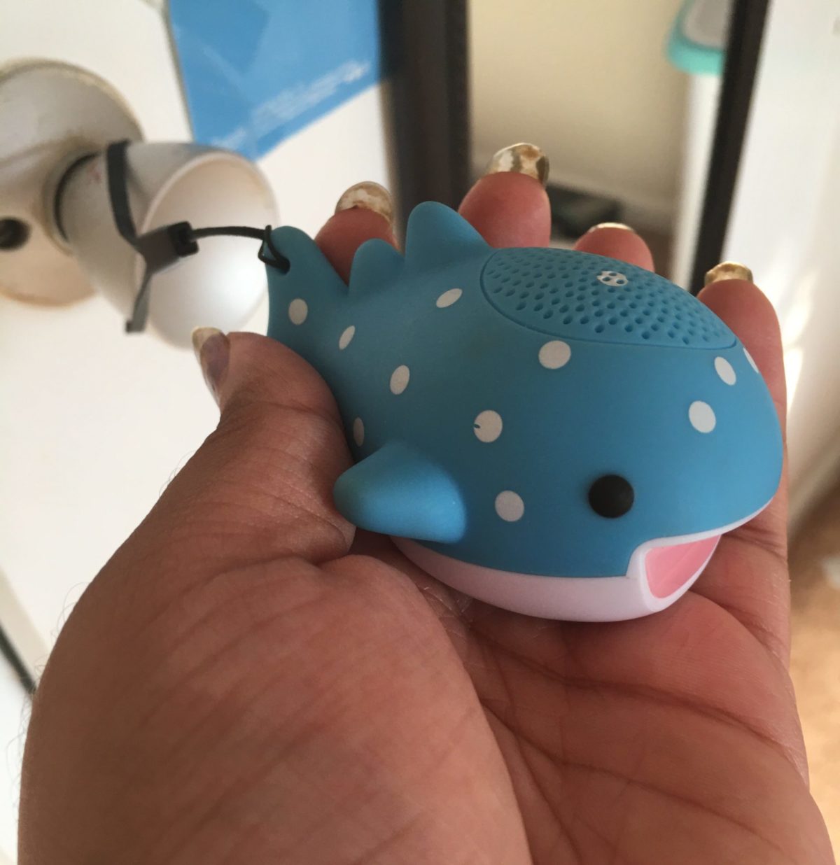 hand holds whale speaker